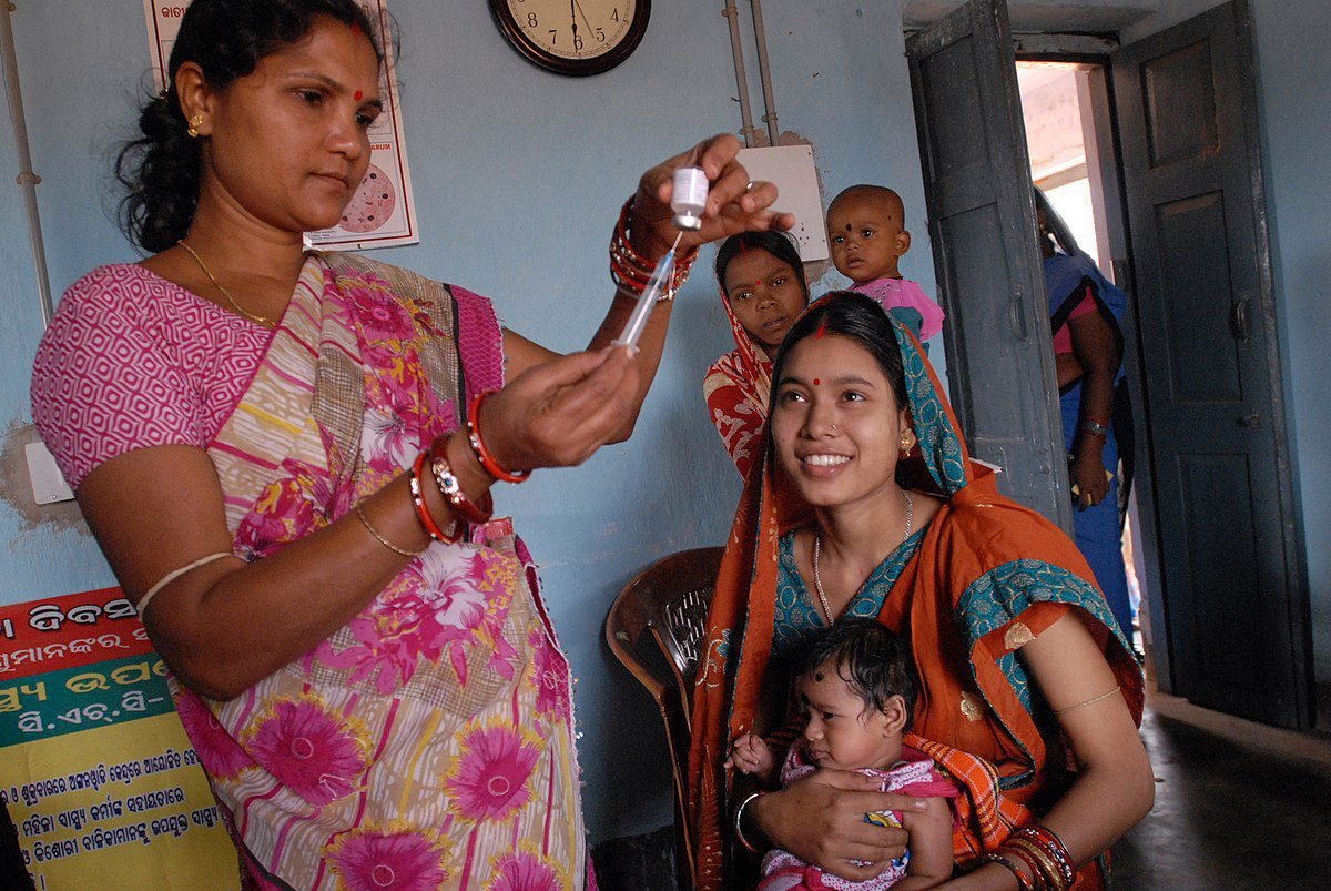 Community health worker gives a vaccination in Odisha state, India ()